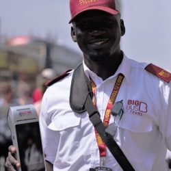 big bus tours worker holding ecr device